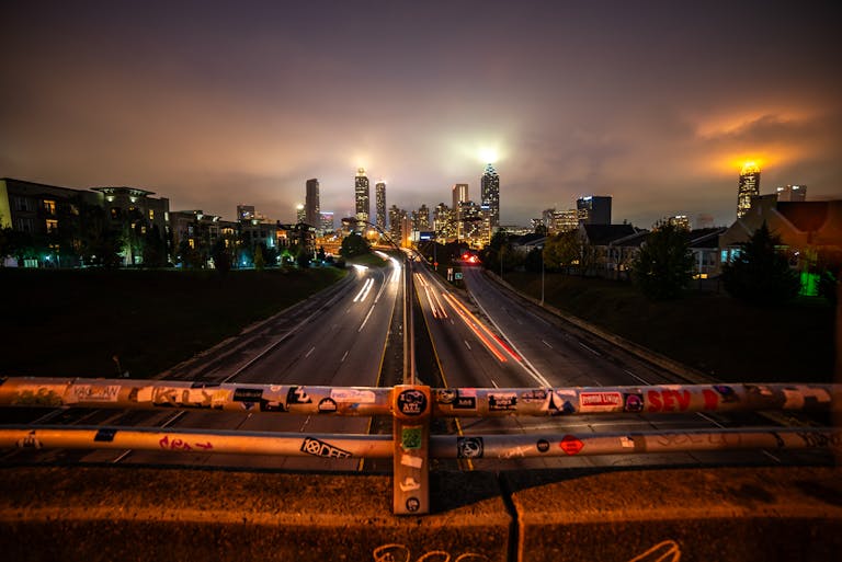 Stunning night shot of the Atlanta skyline with streaking headlights creating dynamic motion. events in atlanta