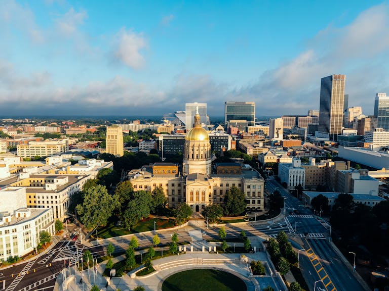 Stunning aerial view of the Georgia State Capitol in downtown Atlanta under a clear blue sky.