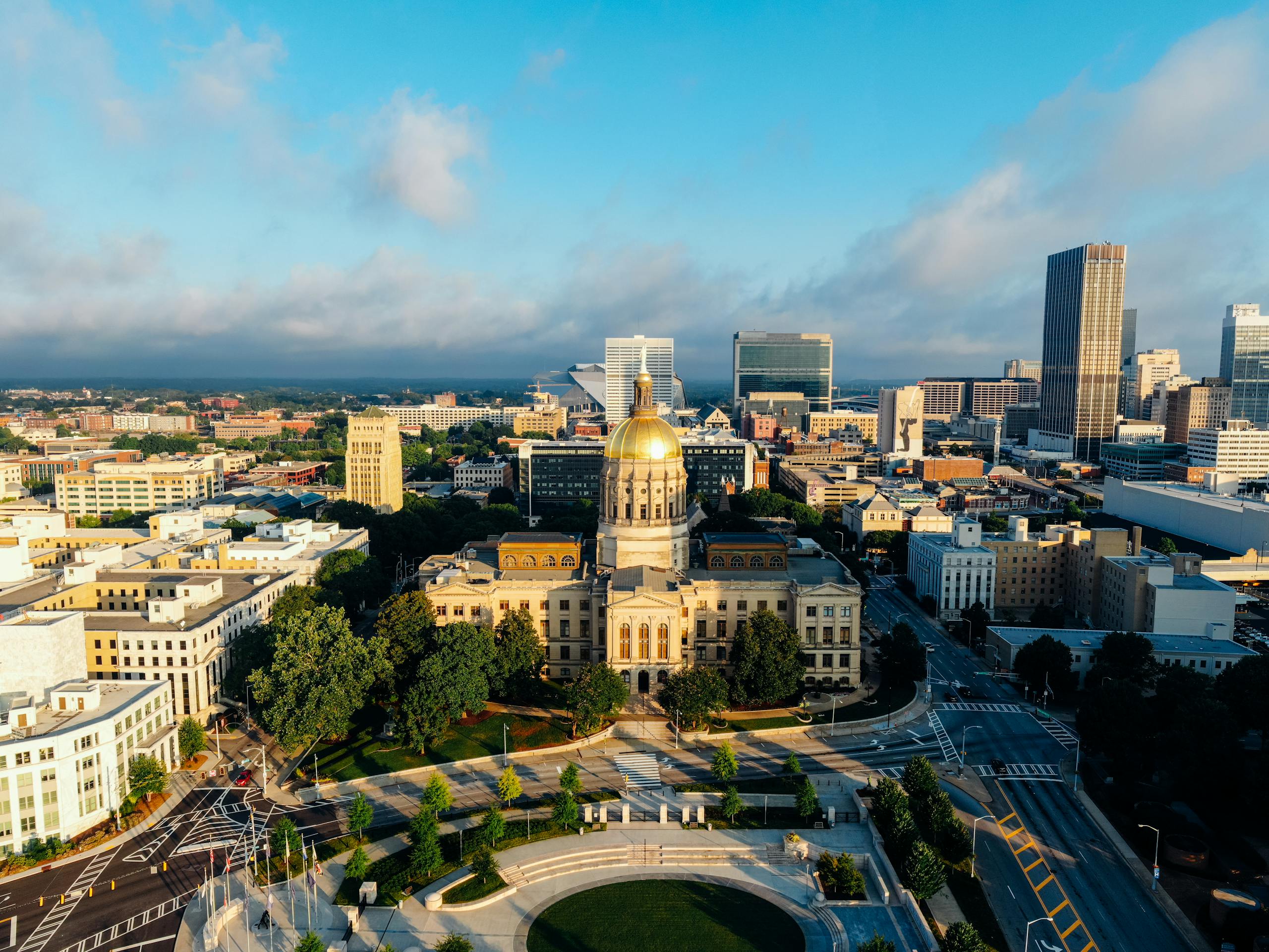 Stunning aerial view of the Georgia State Capitol in downtown Atlanta under a clear blue sky.