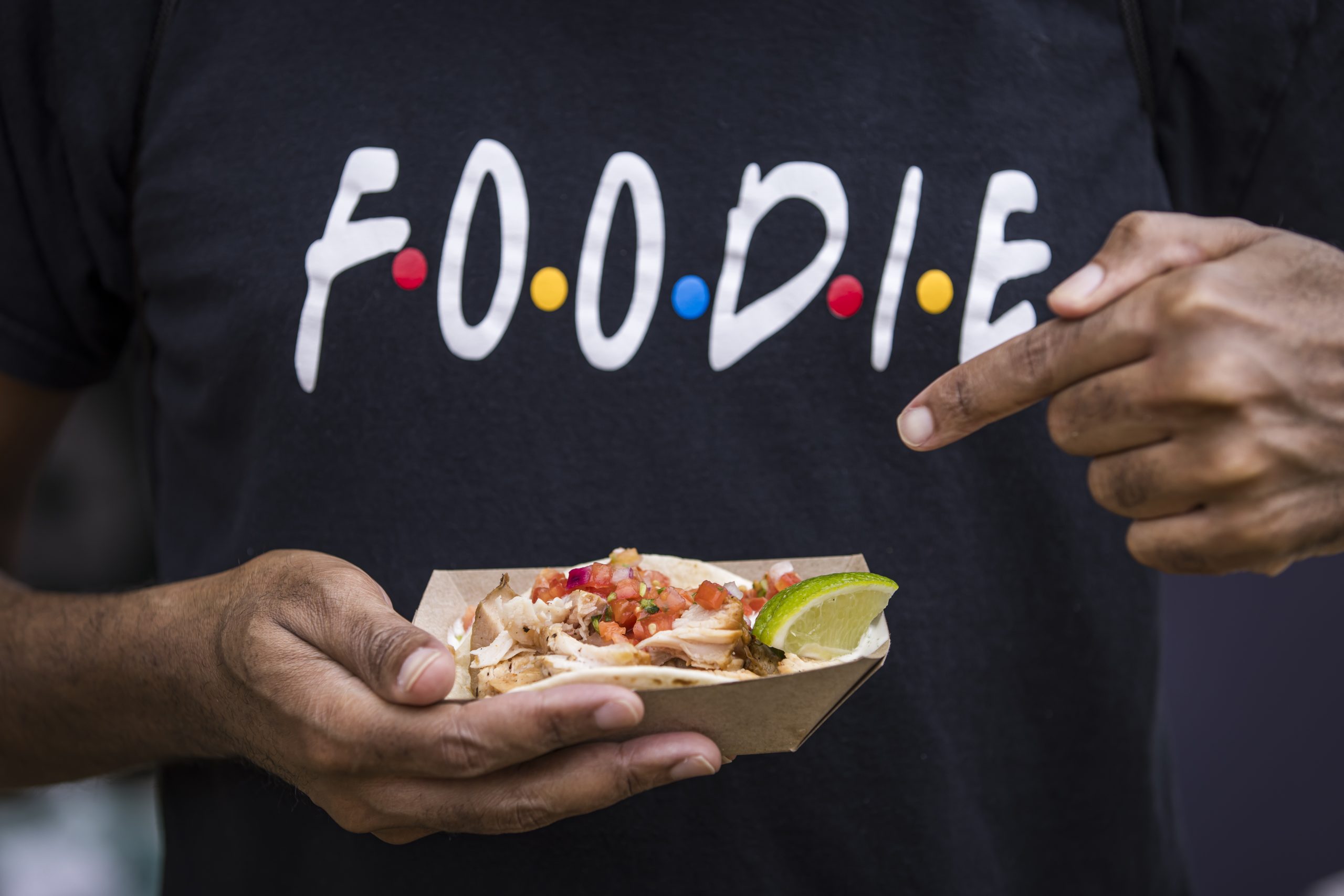 Festival guest enjoying a taco at the Atlanta Food & Wine Festival Tasting Tents